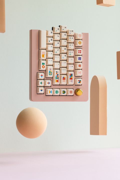 The right half hovering over a peach sphere and an arch, with a brass knob beside the arrow keys