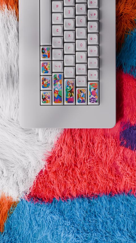 Close-up 3D render of colorful abstract keycaps on a keyboard set against a multicolor shag rug