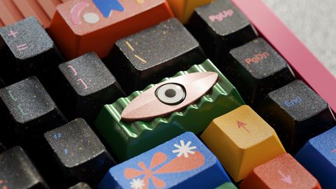 The artisan in the corner of a pink keyboard, surrounded by Motif's novelty keycaps