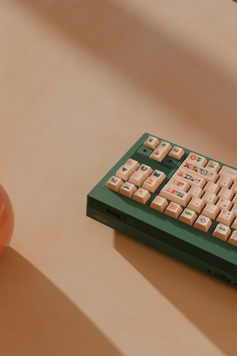 3D-rendered white keyboard centered on a multicolor patchwork shag rug