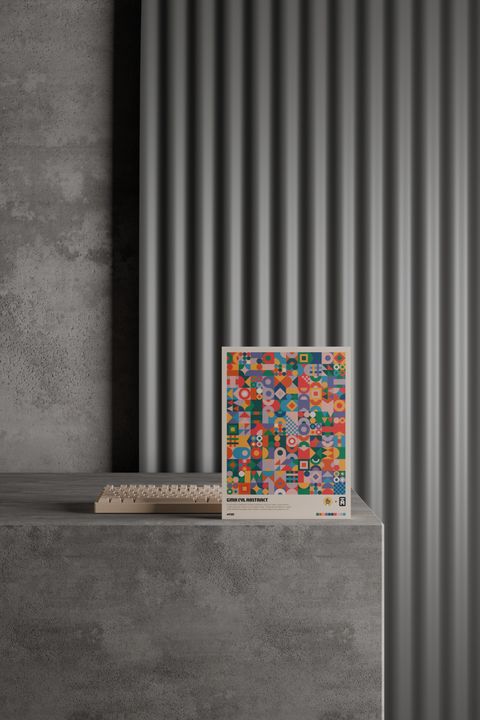 The Abstract box standing on a concrete plinth in front of a fluted grey wall, a cream keyboard behind it