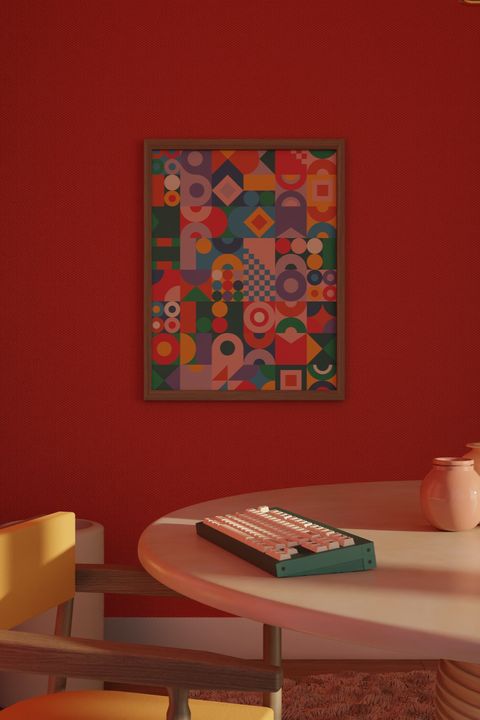 3D-rendered green keyboard on a round pink table below a framed geometric-pattern poster on a red wall
