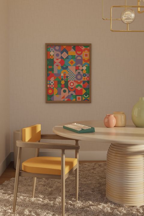 A warm dining room: a cream keyboard on a round table beside a yellow chair, with the Abstract pattern framed on the wall above