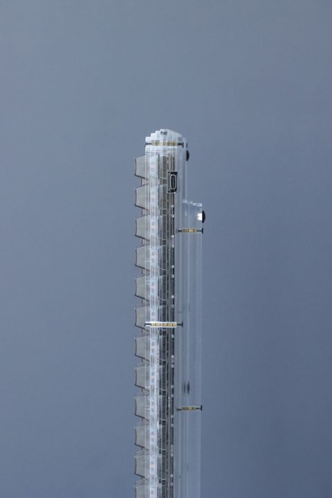 Clear acrylic mechanical keyboard photographed edge-on, showing its translucent case and side connector